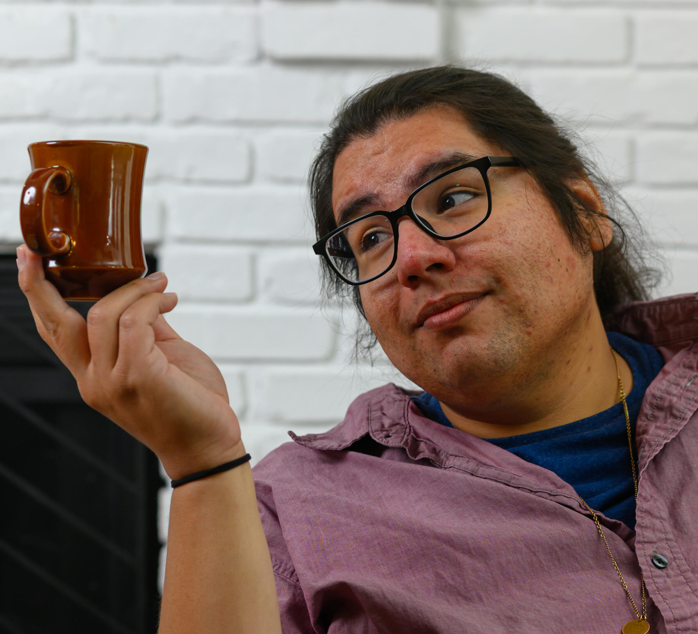 Tyler Corbine standup comedian Tyler Corbine staring comically at a coffee cup
